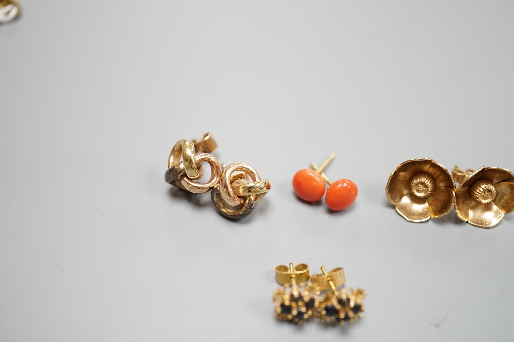 A pair of 750 yellow metal and coral bead ear studs, gross weight 1.8 grams and three pairs of modern 9ct earrings including knot and gem set, gross weight 12.2 grams.